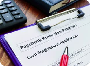 photograph of a paycheck protection program loan forgiveness application on a clipboard