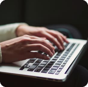 photo of hands typing on a computer