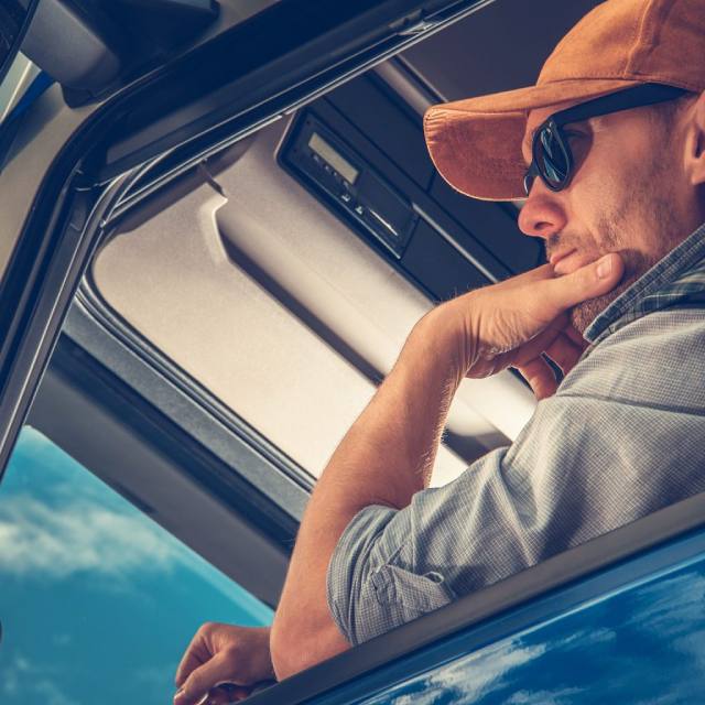 Stock photo of a trucker in the cab