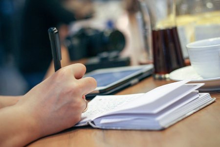 Stock image of a person taking notes