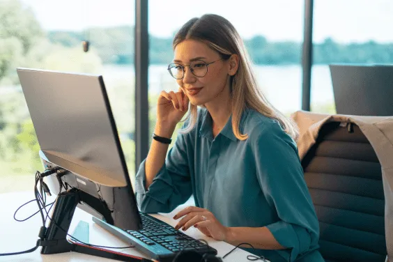 woman using a computer to check her high yield savings account | TAB Save